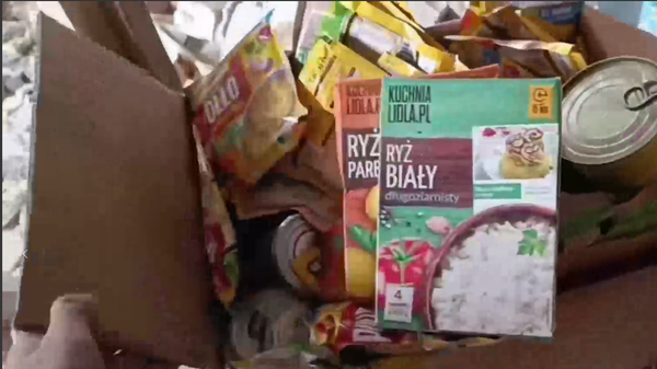 Screengrab of video shot by Russian soldier showing off cache of seized NATO-provided food sent to Ukrainian Army. - Sputnik International