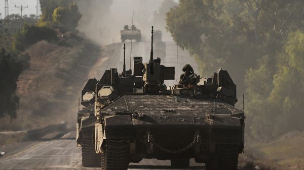 Israeli army armoured vehicles roll towards the border with the Gaza Strip at an undisclosed location in southern Israel on October 15, 2023. - Sputnik International