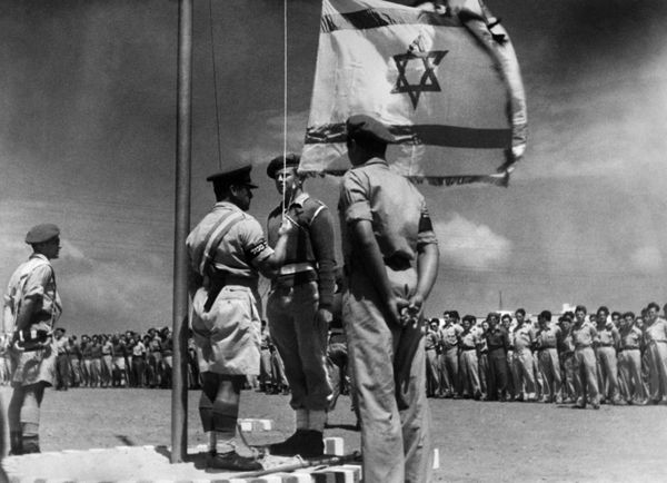 A picture released on June 8, 1948 shows an Israeli officer raising the National Flag for the first time during the celebration of the birth of the Israeli State after its proclamation, on May 14, 1948. A picture released on June 8, 1948 shows an Israeli officer raising the National Flag for the first time during the celebration of the birth of the Israeli State after its proclamation, on May 14, 1948. - Sputnik International