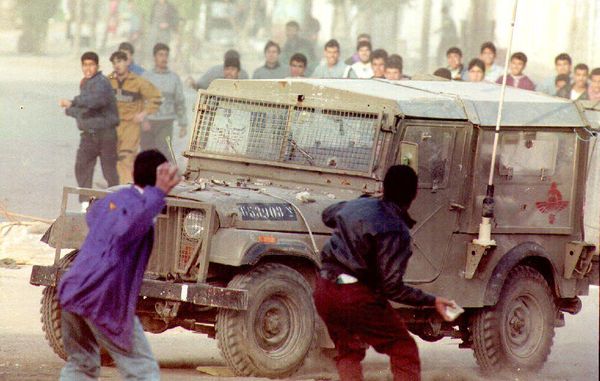 Palestinian youths hurl rocks at an Israeli army jeep during heavy clashes that erupted March 9, 1993, following the killing of an Arab worker by a settler on March 8.During that time, the Palestine-Israel conflict was ongoing, with tensions running high in the West Bank and Gaza Strip. Israeli settlements had been established in the occupied territories, leading to friction and disputes between Israeli settlers and Palestinian residents.The Palestinian youth threw rocks at Israeli soldiers as a form of protest and resistance against the killing of the Arab worker by an Israeli settler. Such actions were a common response to incidents of violence and perceived injustices by Israeli authorities and settlers. The throwing of stones was seen as an act of defiance and resistance to Israeli occupation. Palestinian youths hurl rocks at an Israeli army jeep during heavy clashes that erupted March 9, 1993, following the killing of an Arab worker by a settler on March 8.During that time, the Palestine-Israel conflict was ongoing, with tensions running high in the West Bank and Gaza Strip. Israeli settlements had been established in the occupied territories, leading to friction and disputes between Israeli settlers and Palestinian residents.The Palestinian youth threw rocks at Israeli soldiers as a form of protest and resistance against the killing of the Arab worker by an Israeli settler. Such actions were a common response to incidents of violence and perceived injustices by Israeli authorities and settlers. The throwing of stones was seen as an act of defiance and resistance to Israeli occupation. - Sputnik International
