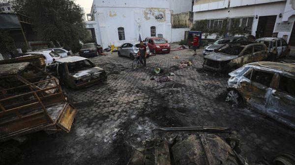 Palestinians look at the site of the explosion at al-Ahli hospital in Gaza City, Wednesday, Oct. 18, 2023. - Sputnik International