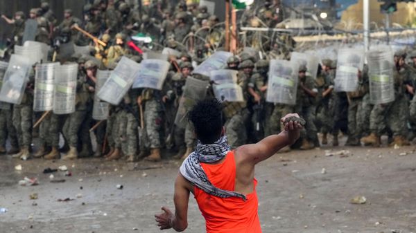 A protester throws a stone at Lebanese army soldiers during a demonstration of solidarity with the Palestinian people in Gaza - Sputnik International