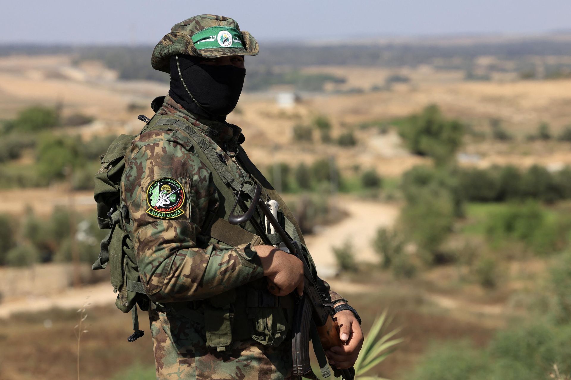 A Palestinian fighter of the al-Qassam Brigades, the armed wing of the Hamas movement, takes part in a military parade to mark the anniversary of the 2014 war with Israel, near the border in the central Gaza Strip on July 19, 2023. - Sputnik International, 1920, 19.10.2023