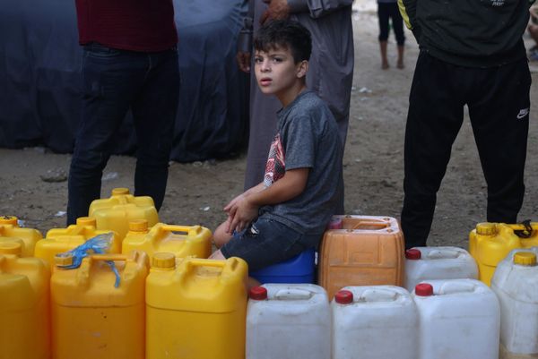 A young Palestinian sits on plastic jerrycans at a water filling point, in Rafah in the southern Gaza Strip, amid the ongoing battles between Israel and the Palestinian group Hamas. Thousands of civilians, both Palestinians and Israelis, have died since October 7, after Palestinian Hamas militants entered southern Israel in an unprecedented attack, triggering a war declared by Israel on Hamas with retaliatory bombings on Gaza. - Sputnik International