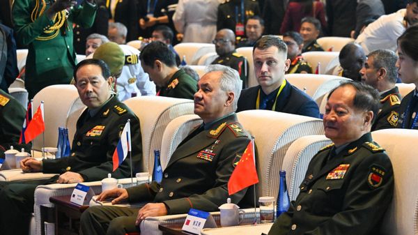 China's Vice Chairman of the Central Military Commission Zhang Youxia (R) and Russia's Defence Minister Sergei Shoigu (C) attend the Xiangshan Forum in Beijing on October 30, 2023 - Sputnik International