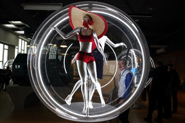 An onlooker examines an exhibit at the Atom pavilion. - Sputnik International
