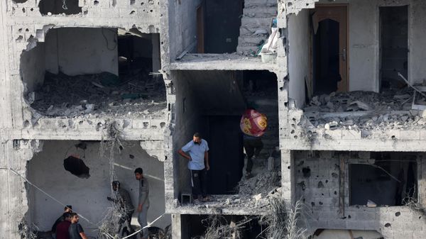 People salvage some belongings from a damaged building following Israeli bombing on Rafah in the southern Gaza Strip, on November 11, 2023. - Sputnik International
