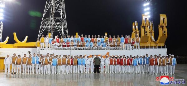 The North Korean leader at the Sohae Space Center being photographed with specialists who worked on the launch. - Sputnik International