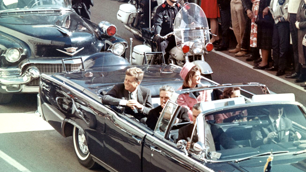 Picture of President Kennedy in the limousine in Dallas, Texas, on Main Street, minutes before the assassination. Also in the presidential limousine are Jackie Kennedy, Texas Governor John Connally, and his wife, Nellie. 22 November 1963 - Sputnik International