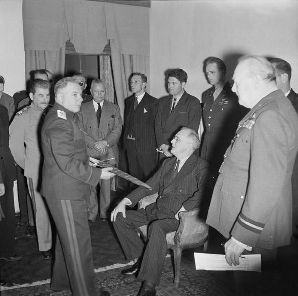 The Tehran Conference (November 28, 1943 – December 1, 1943). Marshal Kliment Voroshilov shows the Stalingrad Sword to the US President Franklin D. Roosevelt in the conference room at the Soviet Embassy in Teheran, Iran (November 28, 1943). The UK Prime Minister Winston Churchill and Marshal Joseph Stalin are also present. - Sputnik International