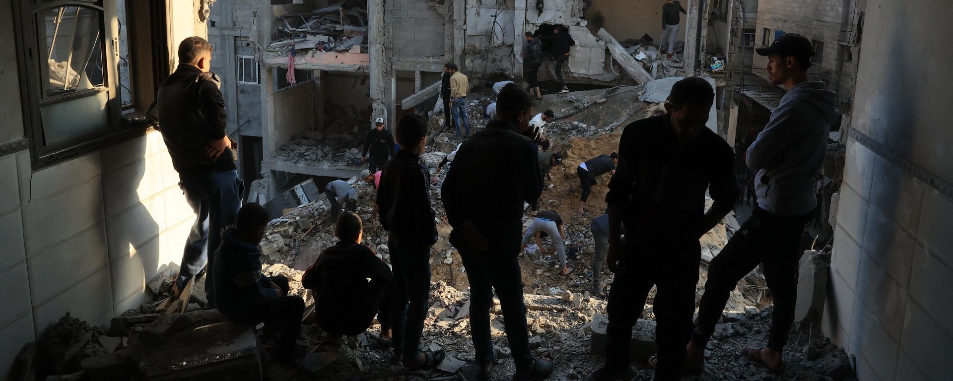 Palestinians inspect the destruction around residential buildings following Israeli air strikes in the Rafah refugee camp in the southern Gaza Strip on December 1, 2023, as fighting resumed shortly after the expiration of a seven-day truce between Israel and Hamas militants Palestinians inspect the destruction around residential buildings following Israeli air strikes in the Rafah refugee camp in the southern Gaza Strip on December 1, 2023, as fighting resumed shortly after the expiration of a seven-day truce between Israel and Hamas militants - Sputnik International, 1920, 11.12.2023