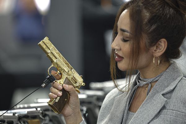 A visitor from Kazakhstan tests a gun during the opening day of the 3rd edition of the Egypt Defence Expo. - Sputnik International