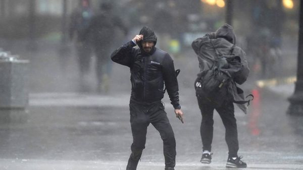 Pedestrians are buffeted by wind and rain as they cross a street, Monday, Dec. 18, 2023, in Boston. A storm moving up the East Coast brought heavy rain and high winds to the Northeast on Monday, threatening flooding, knocking out power to hundreds of thousands. - Sputnik International