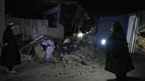 Ma Chengyun at left looks at this collapsed house where he pulled his grandson out from in Yangwa village near Dahejia town in northwestern China's Gansu province, Wednesday, Dec. 20, 2023. A strong overnight earthquake rattled a mountainous region of northwestern China, authorities said Tuesday, destroying homes, leaving residents out in a below-freezing winter night and killing many in the nation's deadliest quake in nine years. - Sputnik International