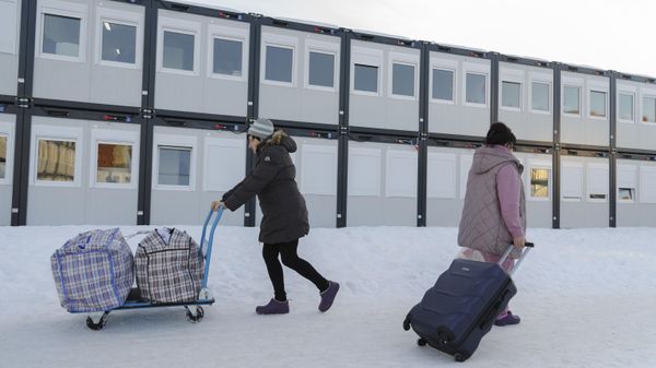 Women carry their belongings at a modular town for refugees from Ukrainian regions in Lvov, Ukraine - Sputnik International