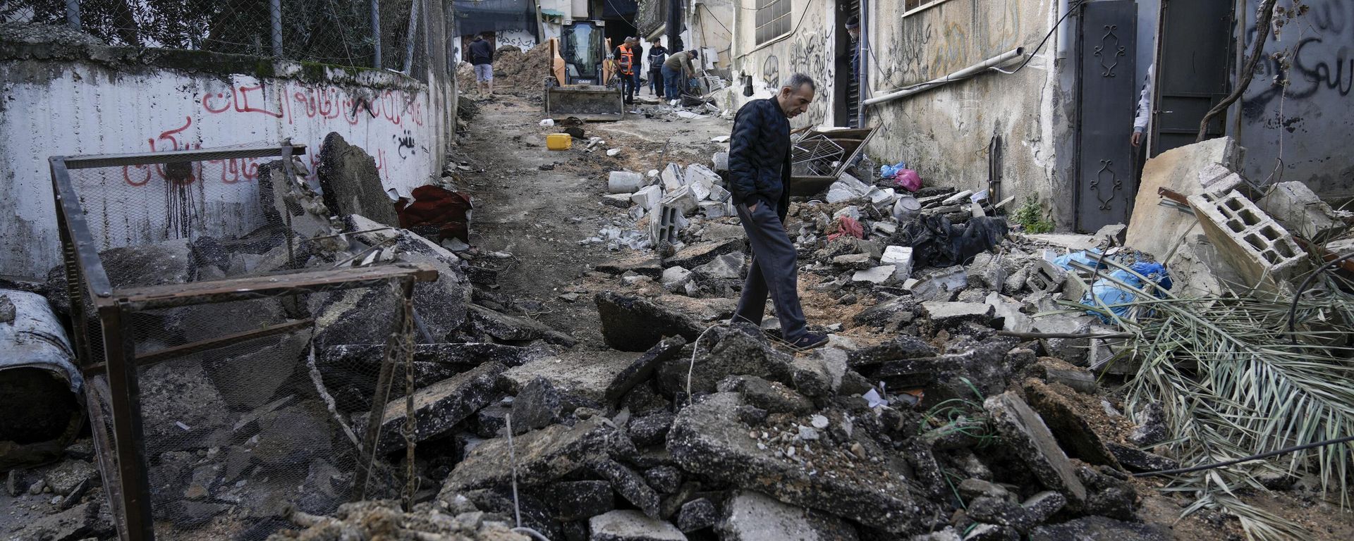 Palestinians walk through the aftermath of the Israeli military raid on Nur Shams refugee camp in the West Bank, Wednesday, Dec. 27, 2023. Israel's forces raided a refugee camp in the northern occupied West Bank, killing at least six Palestinians, Palestinian health authorities said early Wednesday. Palestinians walk through the aftermath of the Israeli military raid on Nur Shams refugee camp in the West Bank, Wednesday, Dec. 27, 2023. Israel's forces raided a refugee camp in the northern occupied West Bank, killing at least six Palestinians, Palestinian health authorities said early Wednesday. - Sputnik International, 1920, 28.12.2023