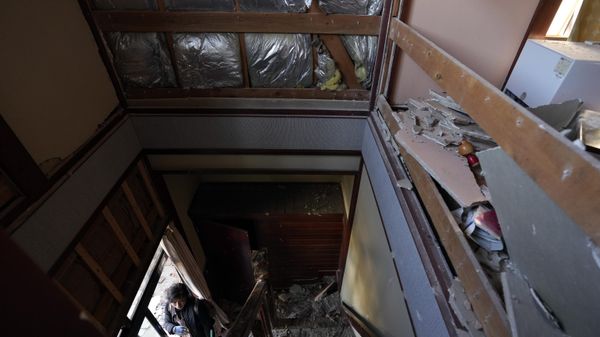 A person looks at a damaged house caused by powerful earthquake Tuesday, Jan. 2, 2024, near Anamizu town, Ishikawa Prefecture, Japan.  - Sputnik International