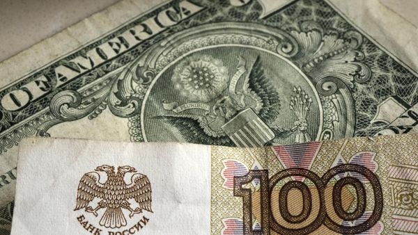 One hundred rubles banknote is pictured in front of a one US dollar banknote, Gelsenkirchen, Germany, Monday, April 25, 2022.  - Sputnik International