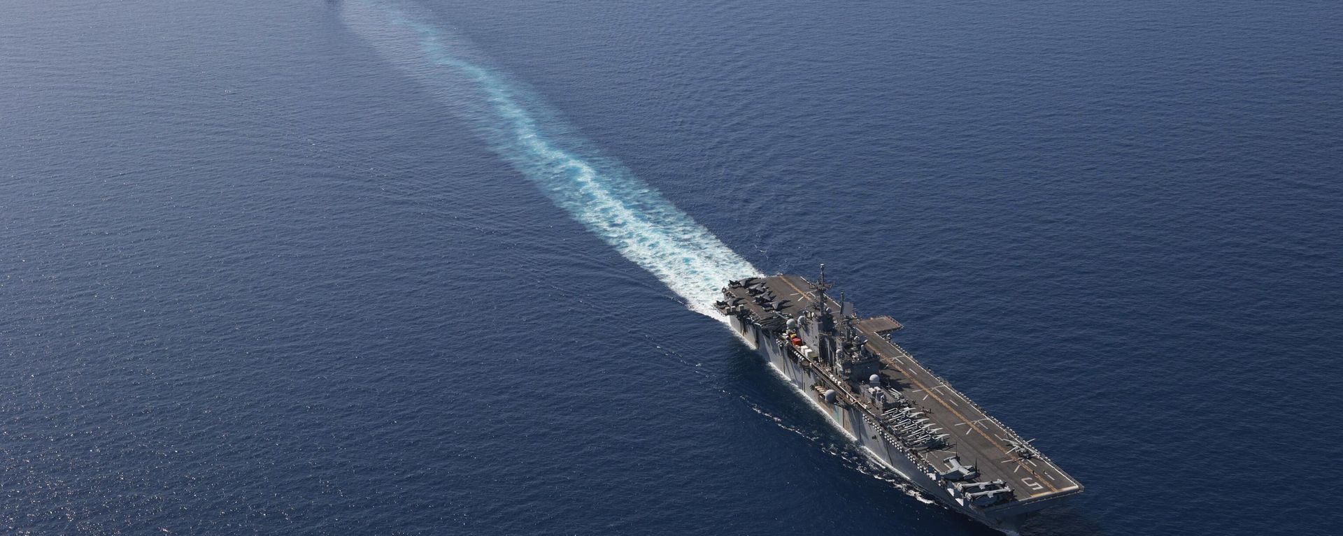 In this photo released by the U.S. Navy, the amphibious assault ship USS Bataan, front, and the landing ship USS Carter Hall, back travel through the Red Sea - Sputnik International, 1920, 12.05.2024