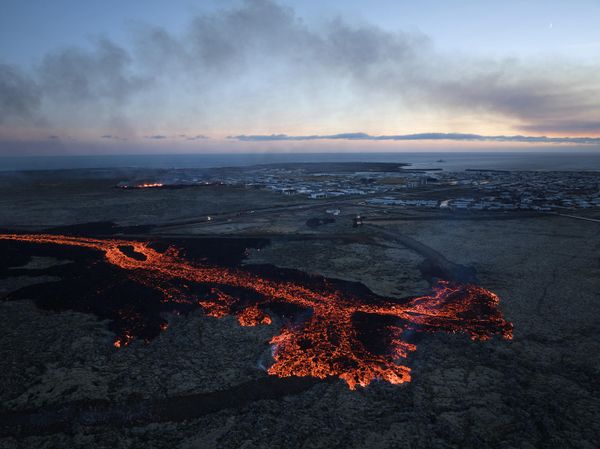 Lava explosions and billowing smoke are seen near residential buildings in the southwestern Icelandic town of Grindavik after a volcanic eruption. - Sputnik International