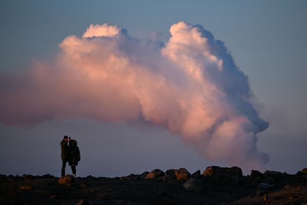 People watch the billowing smoke during a volcanic eruption north of the southwestern Icelandic town of Grindavik. - Sputnik International