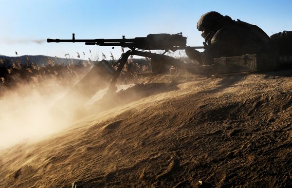 A soldier fires a large-caliber machine gun during Pacific Fleet exercises at a training range. - Sputnik International