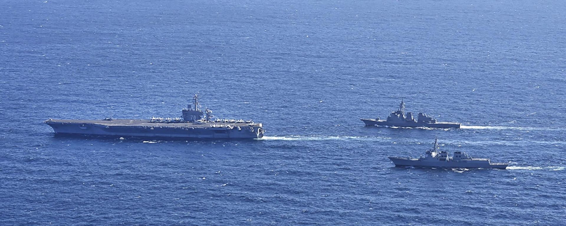 Aircraft carrier USS Carl Vinson, left, sails with South Korean Navy's Aegis destroyer King Sejong the Great and Japan's Maritime Self-Defense Force Aegis destroyer Kongou in the international waters of the southern coast of Korean peninsular during a recent joint drill in 2024 Aircraft carrier USS Carl Vinson, left, sails with South Korean Navy's Aegis destroyer King Sejong the Great and Japan's Maritime Self-Defense Force Aegis destroyer Kongou in the international waters of the southern coast of Korean peninsular during a recent joint drill in 2024 - Sputnik International, 1920, 17.01.2024