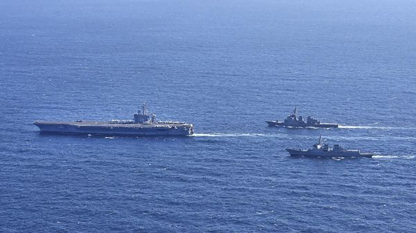 Aircraft carrier USS Carl Vinson, left, sails with South Korean Navy's Aegis destroyer King Sejong the Great and Japan's Maritime Self-Defense Force Aegis destroyer Kongou in the international waters of the southern coast of Korean peninsular during a recent joint drill in 2024 - Sputnik International
