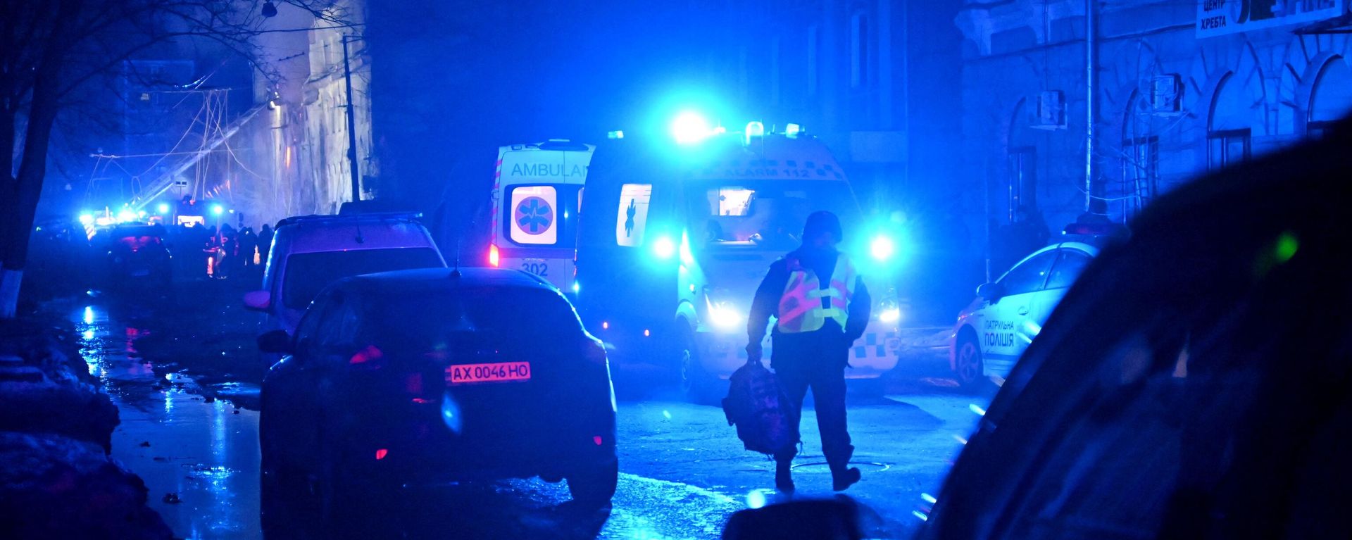 A law enforcement officer walks past ambulances parked at the site of a missile attack in Kharkov late on January 16 A law enforcement officer walks past ambulances parked at the site of a missile attack in Kharkov late on January 16 - Sputnik International, 1920, 22.01.2024