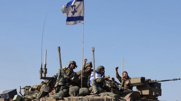 Israeli soldiers in an armoured vehicle convoy returning from the Palestinian territory on January 15, 2024. - Sputnik International