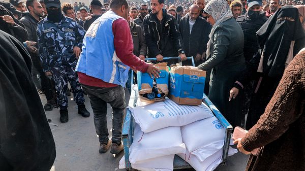 Workers of the United Nations Relief and Works Agency for Palestine Refugees (UNRWA) hand out flour rations and other supplies to people at an UNRWA warehouse in Rafah in the southern Gaza Strip on December 12, 2023, amid continuing battles between Israel and the militant group Hamas Workers of the United Nations Relief and Works Agency for Palestine Refugees (UNRWA) hand out flour rations and other supplies to people at an UNRWA warehouse in Rafah in the southern Gaza Strip on December 12, 2023, amid continuing battles between Israel and the militant group Hamas - Sputnik International