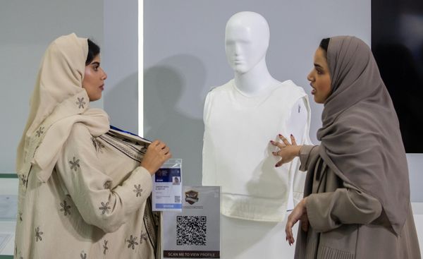 Visitors look at a bulletproof vest on display at the World Defense Show 2024. - Sputnik International