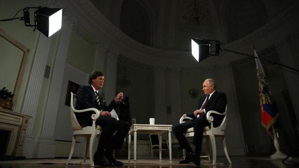 Russian President Vladimir Putin listens to a question during an interview with US journalist Tucker Carlson at the Kremlin in Moscow, Russia. - Sputnik International