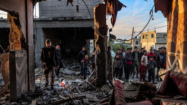 People inspect debris and rubble in a building heavily damaged by Israeli bombardment, in Rafah in the southern Gaza Strip on February 11, 2024 - Sputnik International