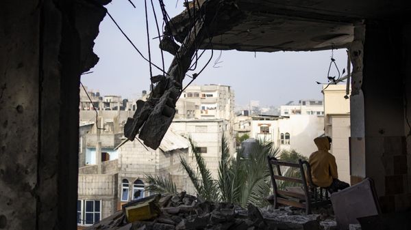 A Palestinian sits in his house destroyed in an Israeli strike in Rafah, Gaza Strip, Saturday, Feb.10, 2024 - Sputnik International