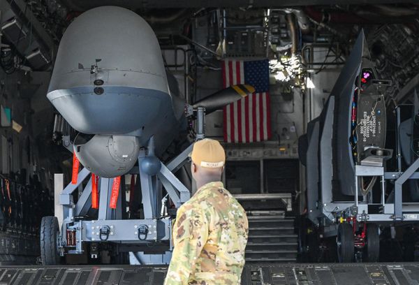 A visitor looks at a USAF Reaper drone inside a C17 Globemaster aircraft.  - Sputnik International