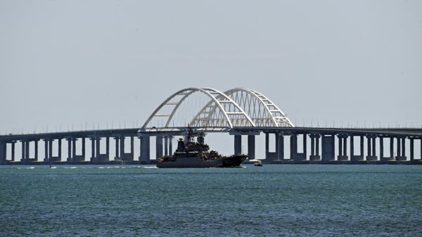 A Russian Navy amphibious landing ship that was deployed to transport cars across the Kerch Strait, sails past the Crimean Bridge in Kerch, Republic of Crimea, Russia. A Russian Navy amphibious landing ship that was deployed to transport cars across the Kerch Strait, sails past the Crimean Bridge in Kerch, Republic of Crimea, Russia. - Sputnik International