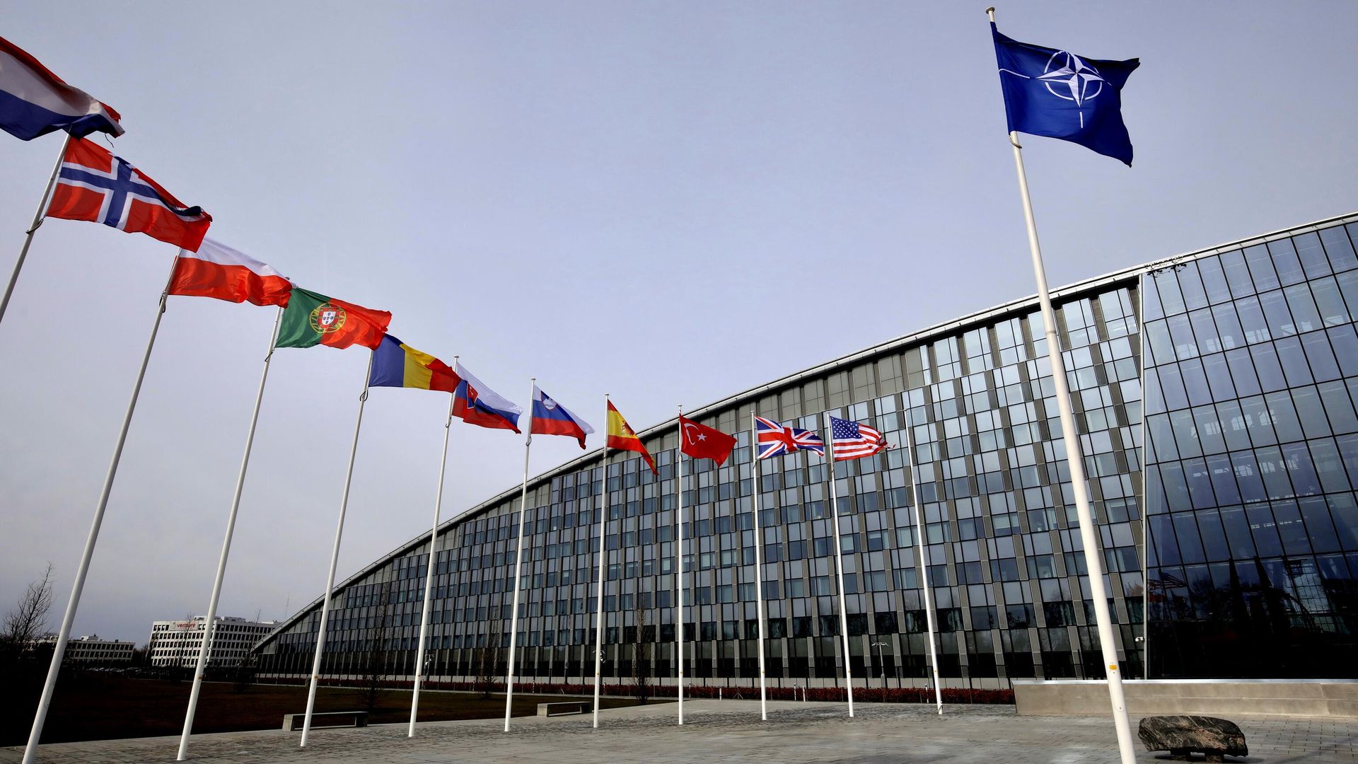 Flags of Alliance members flap in the wind outside NATO headquarters in Brussels, Friday, Feb. 28, 2020.  - Sputnik International, 1920, 14.06.2024