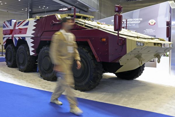 A visitor walks past an armored vehicle on display at Britain's pavilion.  - Sputnik International