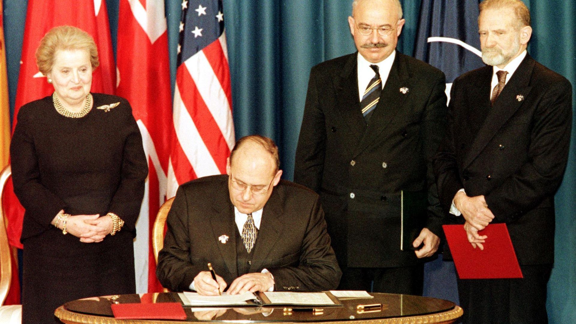 The Minister of Foreign Affairs of the Czech Republic Jan Kavan (seated) signs the accession document that enters the Czech Republic into NATO 12 March 1999 at the Harry Truman library in Independence, MO. Standing are US Secretary of State Madeleine Albright (L), Minister of Foreign Affairs of Hungary Janos Martonyi (C), and Minister of Foreign Affairs of Poland Bronislaw Geremek (R). The Minister of Foreign Affairs of the Czech Republic Jan Kavan (seated) signs the accession document that enters the Czech Republic into NATO 12 March 1999 at the Harry Truman library in Independence, MO. Standing are US Secretary of State Madeleine Albright (L), Minister of Foreign Affairs of Hungary Janos Martonyi (C), and Minister of Foreign Affairs of Poland Bronislaw Geremek (R). - Sputnik International, 1920, 12.03.2024