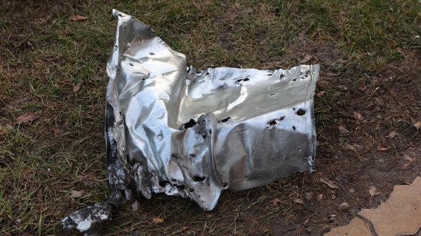 A fragment of a shell lying on the ground after a shelling by the Ukrainian military in Belgorod, Russia - Sputnik International
