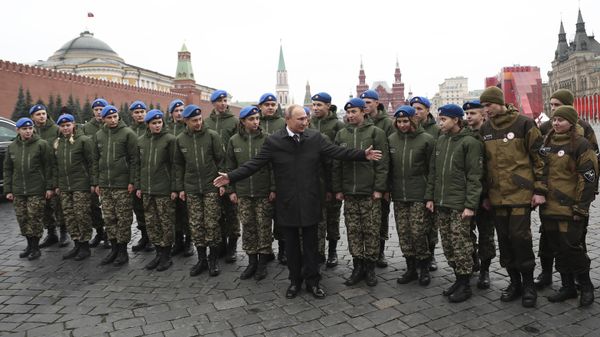 Russian President Vladimir Putin poses for a picture with members of youth organizations during a flower-laying ceremony at the Monument to Minin and Pozharsky at Red Square, during National Unity Day in Moscow, Russia, Monday, Nov. 4, 2019 - Sputnik International