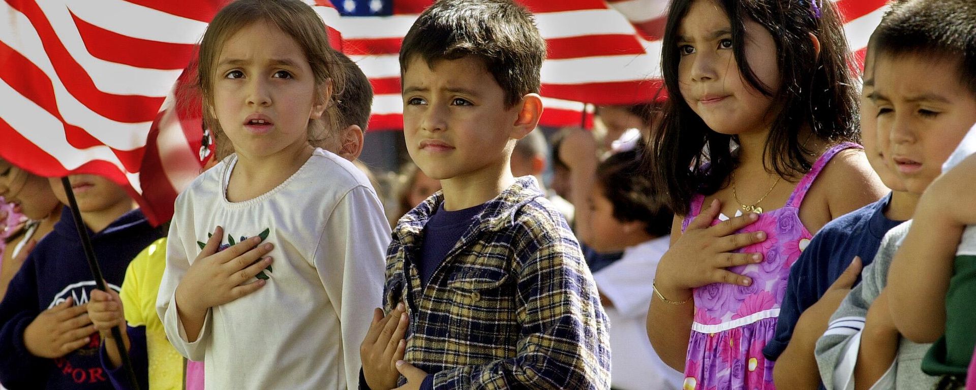 Though some were a bit unsure of the words or exactly where to place your hand over your heart, some of the 700 students at Nevada Avenue Elementary School recite the Pledge of Allegiance, followed by God Bless America, as part of nationwide ceremonies to honor America at 11 a.m. PDT Friday, Oct. 12, 2001, in the Canoga Park district of Los Angeles' San Fernando Valley - Sputnik International, 1920, 19.03.2024