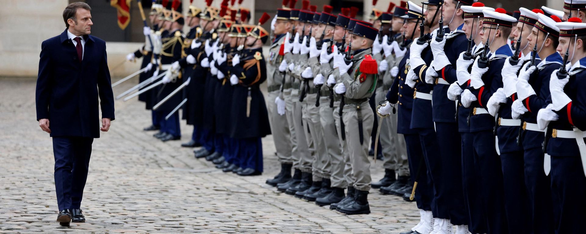 French President Emmanuel Macron reviews troops during a Prise d'armes military ceremony in the courtyard of the Hotel National des Invalides in Paris, on February 19, 2024.  - Sputnik International, 1920, 19.03.2024