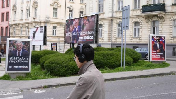 A man stands by posters for former Foreign Minister Ivan Korcok, a pro-Western career diplomat, and Peter Pellegrini, right, who currently serves as Parliament's speaker, two of the nine candidates in the upcoming Slovakia's presidential election, in Bratislava, Slovakia, Friday, March 22, 2024. (AP Photo/Petr David Josek) - Sputnik International