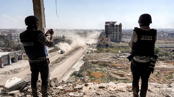Journalists film from atop a damaged building facing the ravaged building of Al-Salam hospital in Khan Yunis - Sputnik International