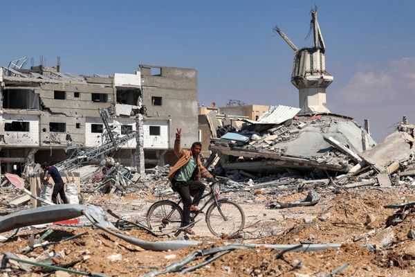 A man rides a bicycle along an obliterated road. - Sputnik International