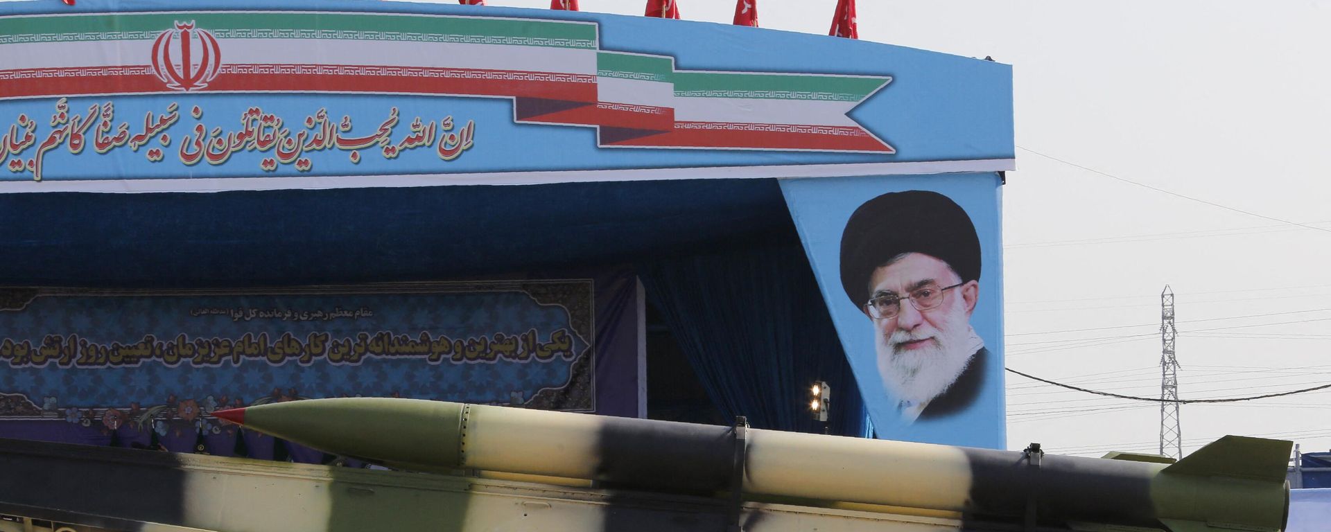 An Iranian military truck carries missiles past a portrait of Iran's Supreme Leader Ayatollah Ali Khamenei during a parade on the occasion of the country's annual army day on April 18, 2018 in Tehran. - Sputnik International, 1920, 17.04.2024