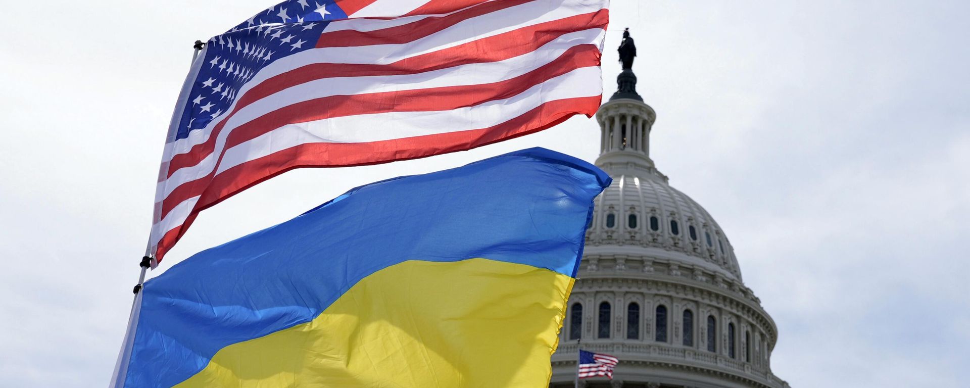 The American and Ukrainian flags wave in the wind outside of the Capitol on Tuesday, April 23, 2024, in Washington. The Senate is moving ahead with $95 billion in war aid to Ukraine, Israel and Taiwan. (AP Photo/Mariam Zuhaib) - Sputnik International, 1920, 16.10.2024