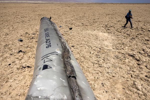 A photographer walks near the remains of a missile that landed on the shore of the Dead Sea a week after the missile barrage fired by Iran on April 13. - Sputnik International